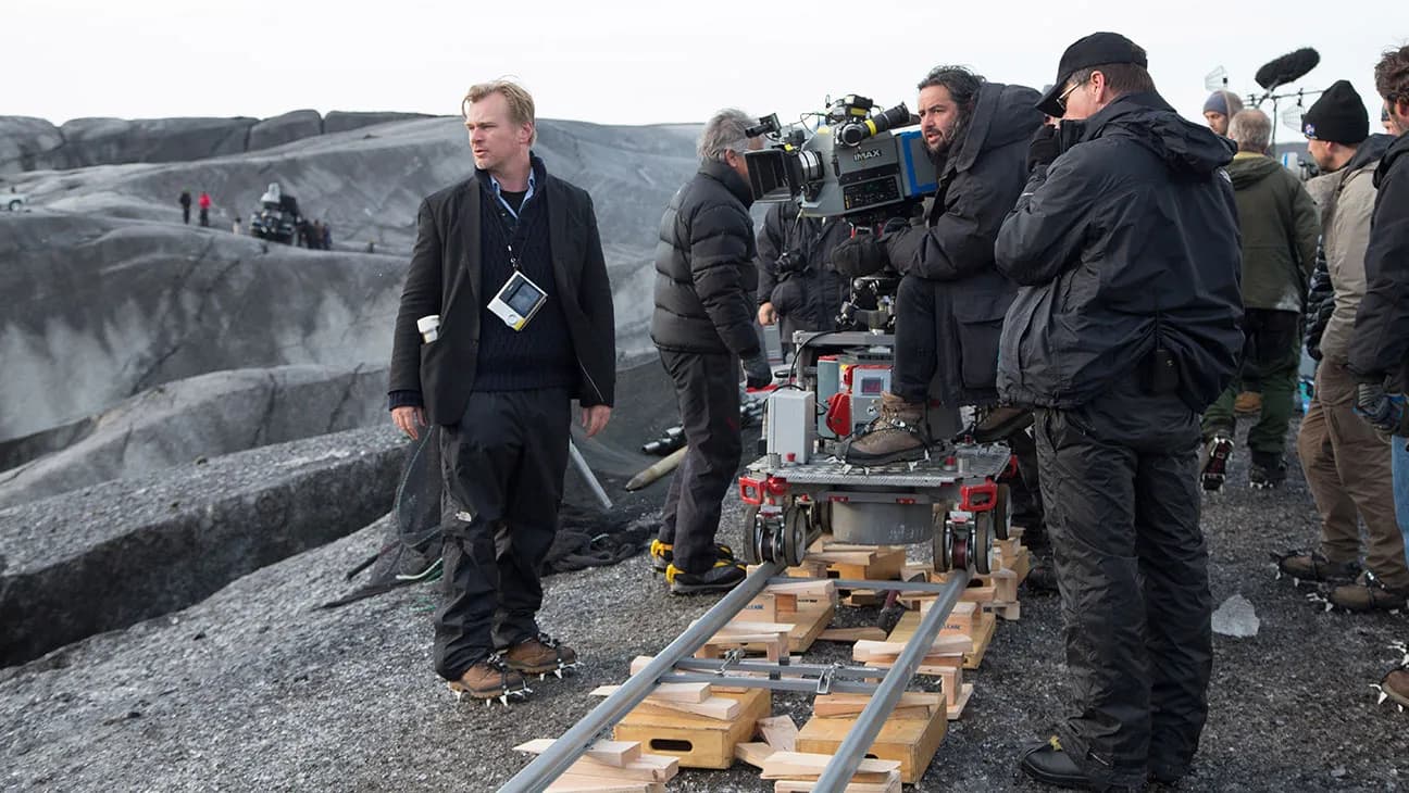 Behind-the-scenes image of Interstellar crew operating IMAX camera equipment on a stark exterior location.