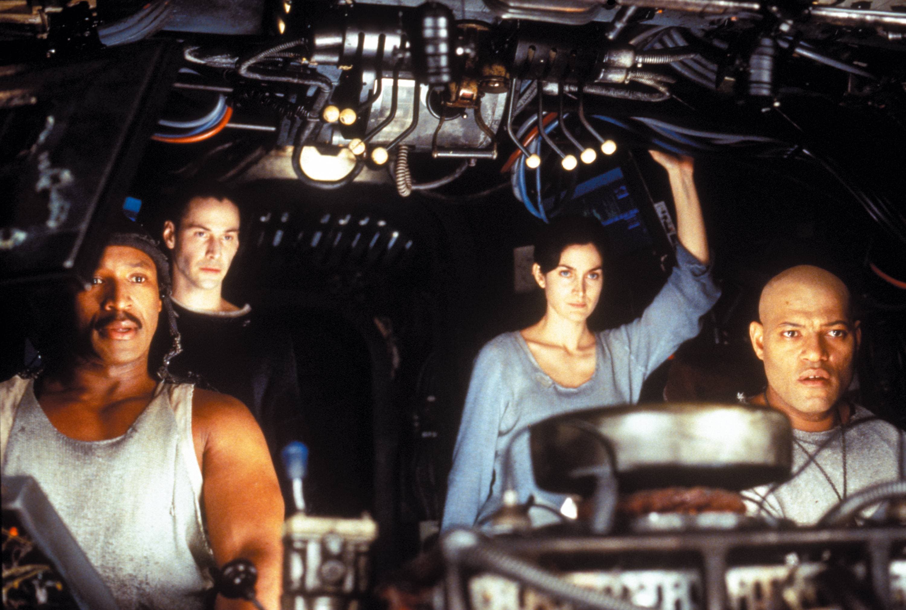 Behind-the-scenes image of cast and crew in the Nebuchadnezzar cockpit set.