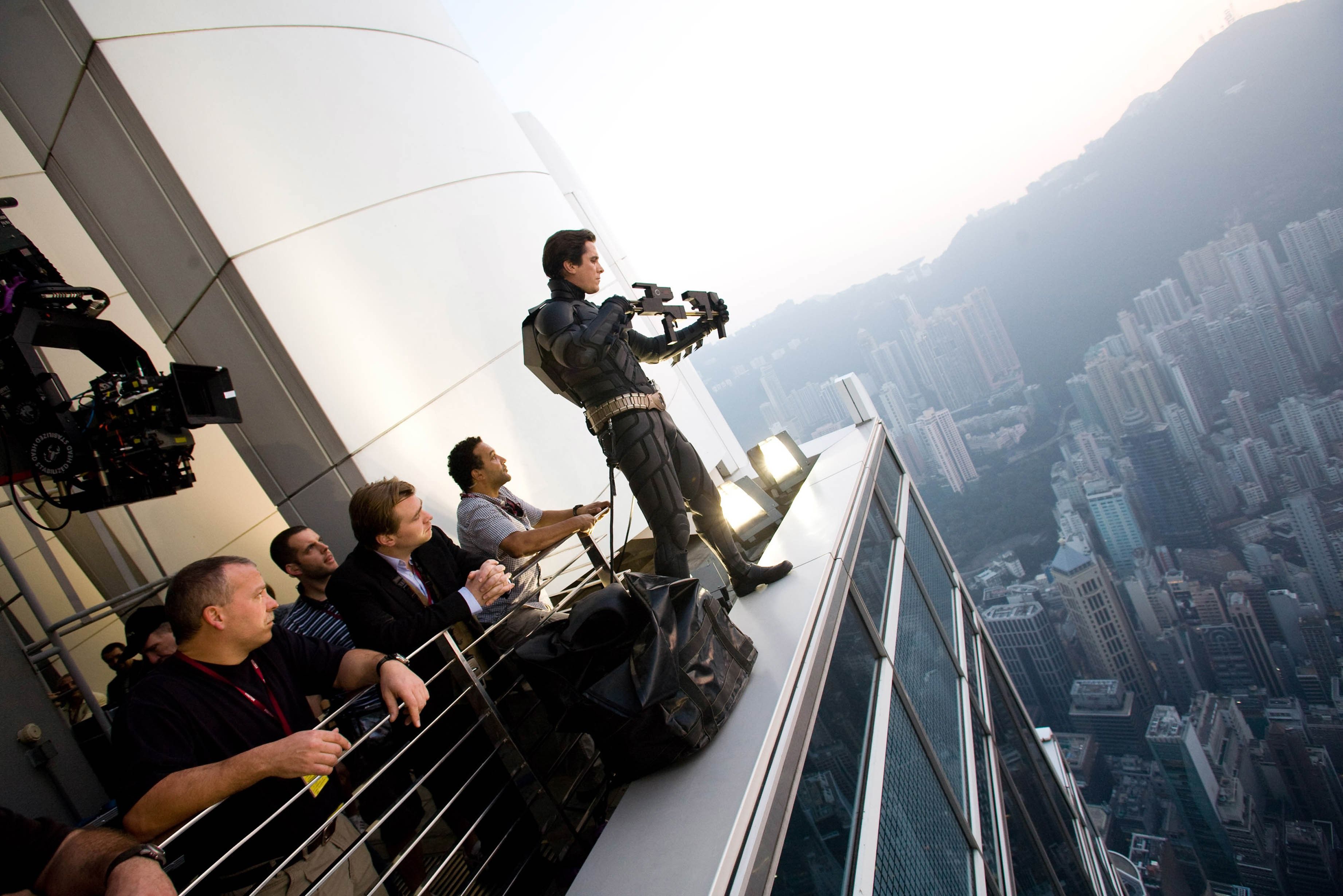 Behind-the-scenes image of The Dark Knight crew filming from a high-rise rooftop with IMAX camera equipment.
