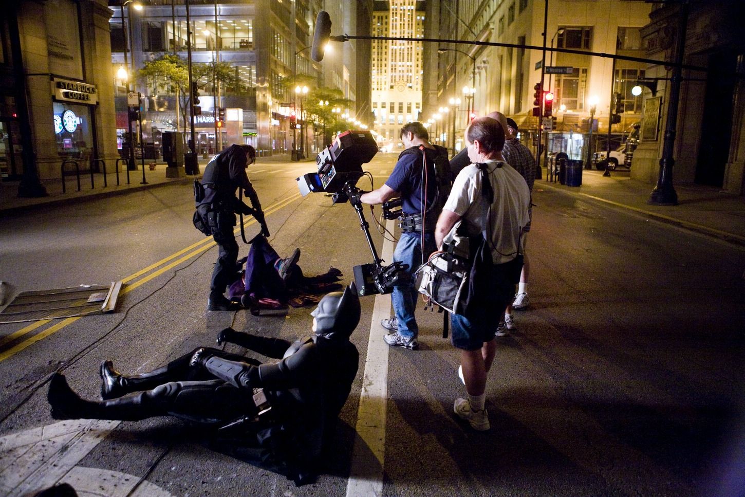 Behind-the-scenes image of crew and performers staging a street action beat for The Dark Knight.