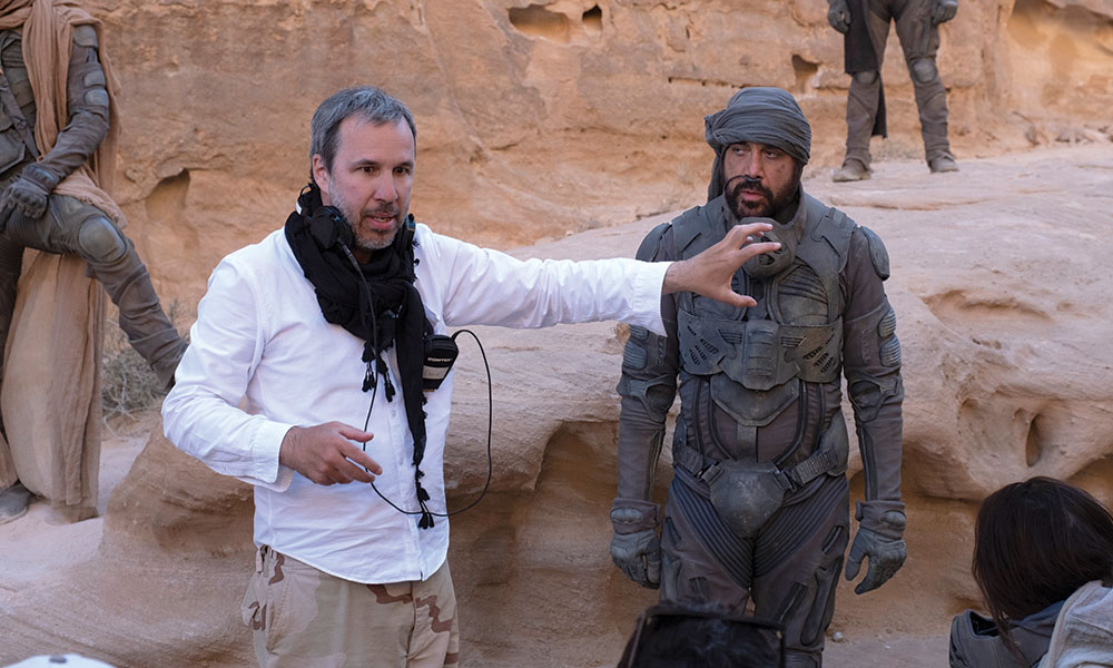 Behind-the-scenes image of Denis Villeneuve working with Javier Bardem on Dune.