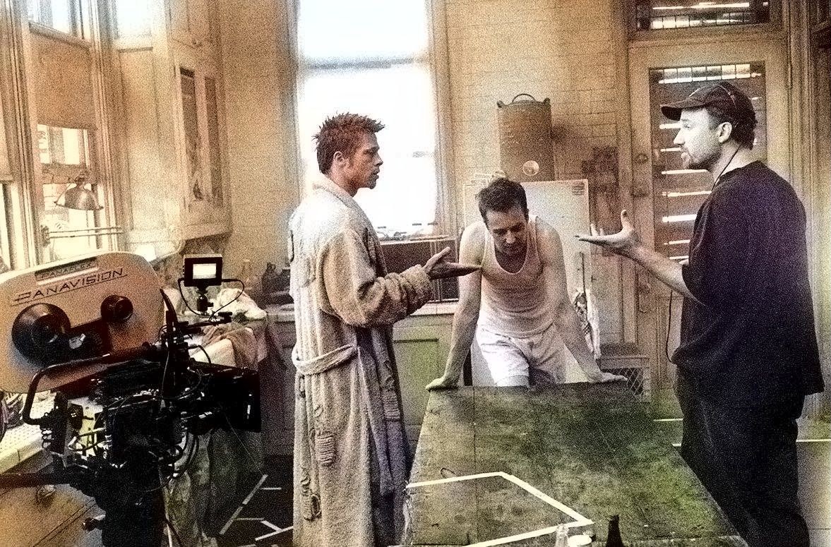 Behind-the-scenes image of actors and crew staging a scene inside the Fight Club boarding-house set.