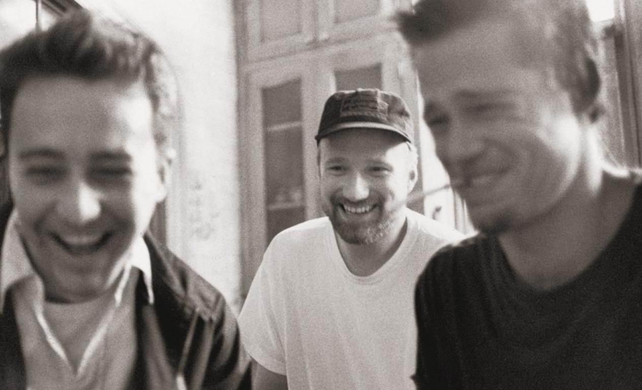David Fincher, Brad Pitt, and Edward Norton photographed candidly during Fight Club production.