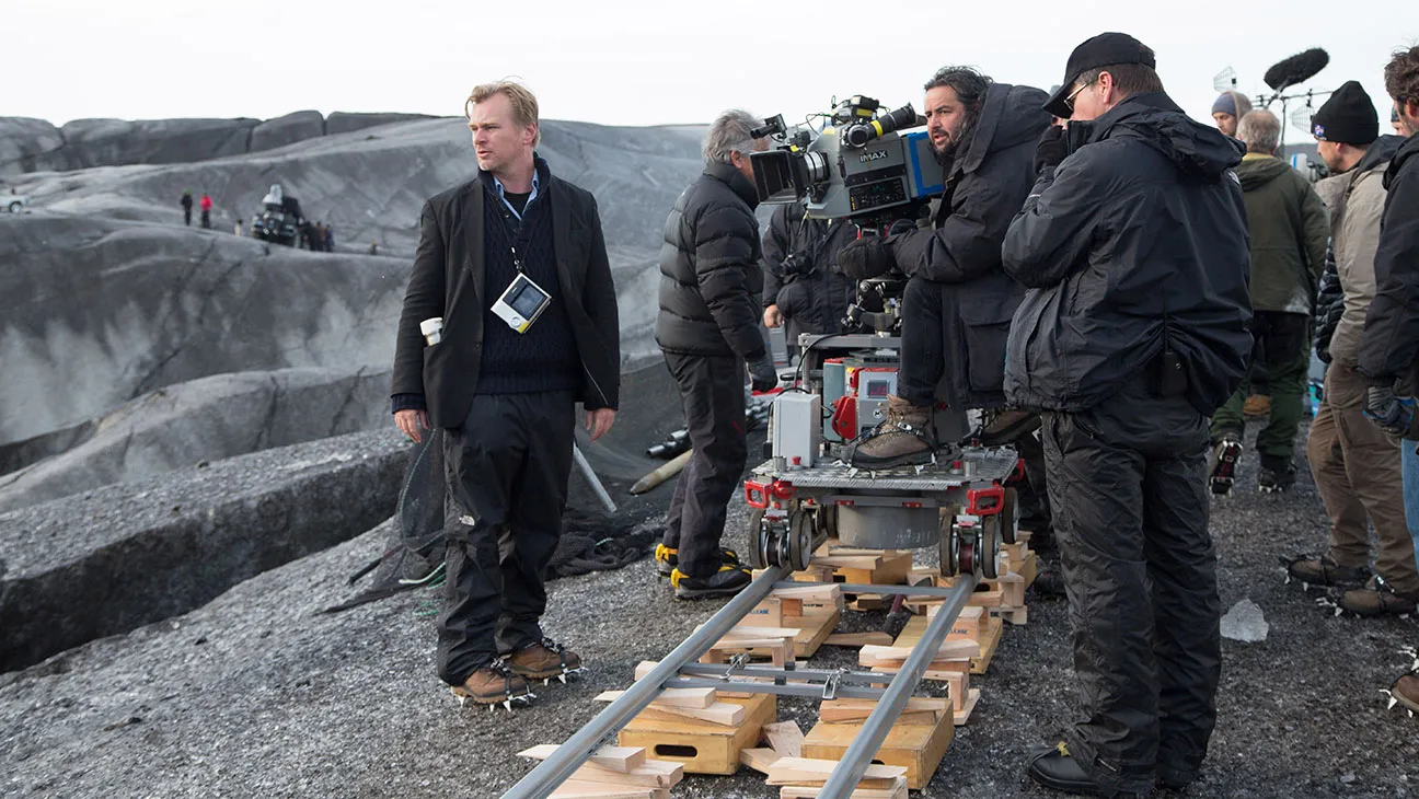 Behind-the-scenes image of Interstellar crew operating IMAX camera equipment on a stark exterior location.