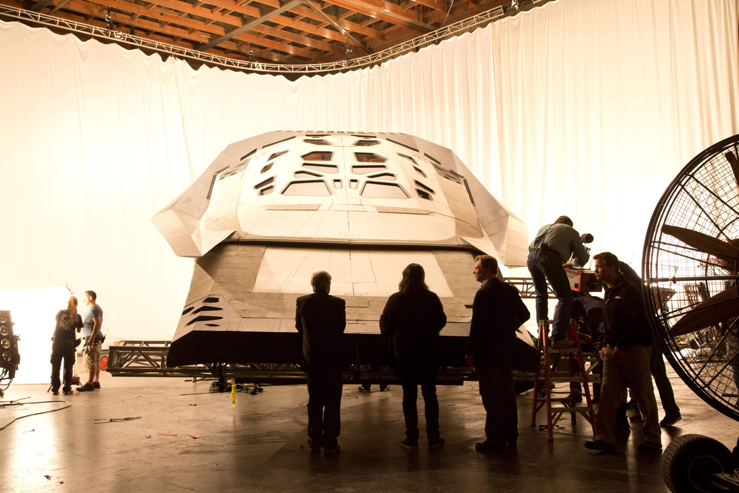 Behind-the-scenes image of the Ranger craft and production crew inside a large hangar setup.